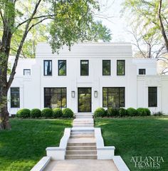 a white house with steps leading up to the front door