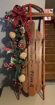 an old sled decorated with pine cones and ornaments