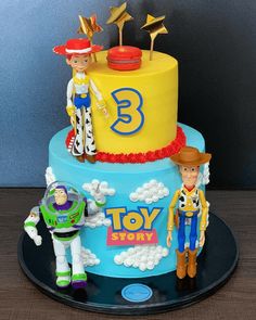 a toy story birthday cake on a black plate