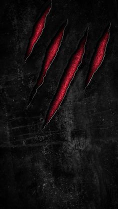 the claws of an animal that is red in color on a black background with scratches