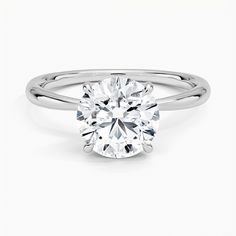 a round brilliant cut diamond engagement ring on a white background with the band around it