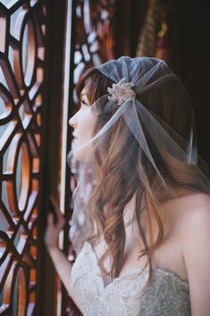 a woman in a wedding dress wearing a veil