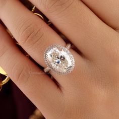 a woman's hand with an engagement ring on it