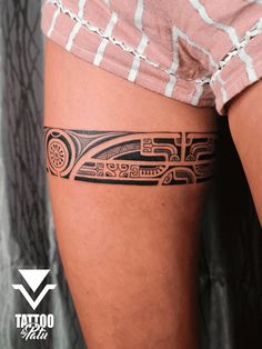 a woman's thigh with a tattoo design on it