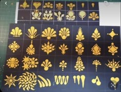 some gold stencils are sitting on a table