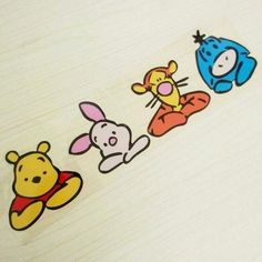 winnie the pooh and friends stickers on a white table top with wood grain