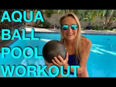 a woman holding a ball in front of a swimming pool with the words aqua ball pool workout