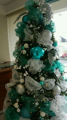 a christmas tree decorated with green and white ornaments