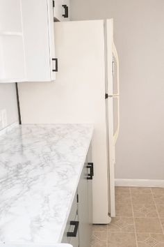 a white refrigerator freezer sitting inside of a kitchen