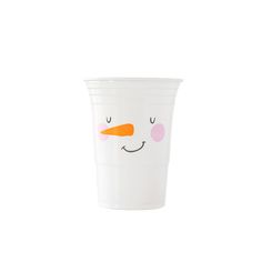 a white cup with a face drawn on the side and an orange carrot sticking out of it