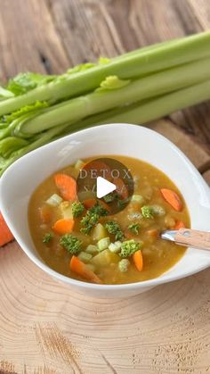 a bowl of soup with carrots and celery