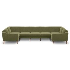 a green sectional couch with wooden legs and arm rests on an isolated white background,