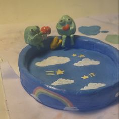 there is a cake that looks like two birds in the sky on top of a pool