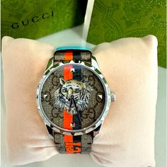 Brand New In Box. 100% Authentic Gucci G-Timeless Tiger Watch Style Ya1264186 This G-Timeless Watch Is Characterised By The Printed Motto 'Gucci Tiger.' References To The Feline Are Often Seen Throughout The Creative Director's Collections As An Expression Of The House's Fascination With The Wild Beauty Of The Natural World. Presented With A Steel Case And Gg Supreme Strap And Dial, The Style Is Completed By Orange And Black Stripes And Light Blue Holders Size 38mm Comes In Exactly As Shown. Inc Luxury Multicolor Watches With Diamond Hour Markers, Luxury Multicolor Watches For Gifts, Luxury Multicolor Watches For Gift, Luxury Multicolor Watches As Gift, Designer Automatic Watches As Gift, Designer Analog Watch With Round Dial, Designer Watches With Analog Display And Round Dial, Designer Analog Display Watch, Designer Watch Accessories With Subdials As A Gift