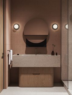 a bathroom with a sink, mirror and lights on the wall above it's counter