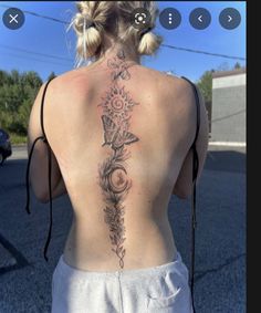 the back of a woman's neck with flowers on it