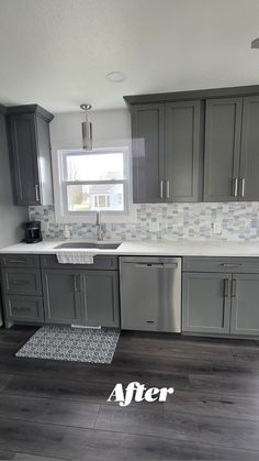 a kitchen with gray cabinets and white counter tops is shown in the foreground, an area rug on the floor that says after