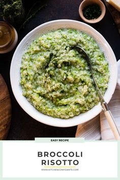 broccoli risotto in a white bowl with a spoon on the side