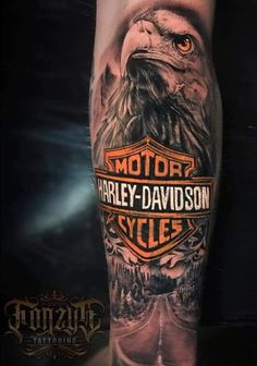 an eagle with the words harley davidson on it's arm is shown in black and grey