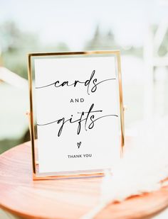 a card and gifts sign sitting on top of a table