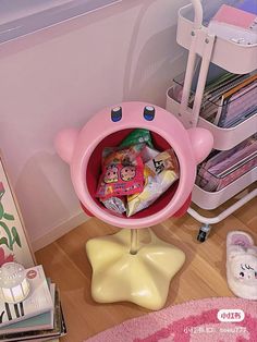 there is a pink bear shaped sink in the corner of this room with magazines and toys