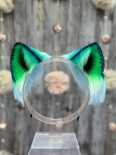 Space themed cat ear headband. White and Blue Ears Airbrushed with Green, Blue and Black coloring! Comes with the black hoop jewelry and star charm! Ears are wired and are posable! Ears come on a metal headband.  My shop's ears and tails are completely hand crafted and might have some slight differences in trimming and airbrushing. PLEASE NOTE: CUSTOMIZATIONS TO ORDERS MUST BE MADE PRIOR TO PURCHASING! WE ARE NOT RESPONSIBLE FOR ANY CUSTOMIZATIONS AFTER PURCHASE IS MADE.  ALL CUSTOM ORDERS ARE F Whimsical Cat Ears Headband For Parties, Adjustable Ears Headband For Costume Party, Black Cat Ears Novelty Headband, Novelty Black Cat Ears Headband, Black Novelty Cat Ears Headband, Whimsical Adjustable Cat Ears Headband, Novelty Cat Ears Hair Accessories, Novelty Cat Ears Hair Accessories For Parties, Party Novelty Cat Ears Hair Accessories