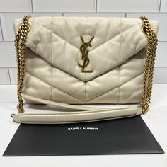 Small Size Dimensions: 11.4l X 6.6h X 4.3w Inches In The Color “Blanc Vintage” With Gold Antique Hardware In Used Condition Bag Has Wear/Discoloration On Corners Has Markings On The Interior Of The Bag 100% Authentic, Comes With Receipt No Dust Bag Or Box Retail $3200 Please Message Me If You Have Any Questions Ysl Blanc Vintage Bag, Yellow Ysl Bag, Gold Leather Bags With Gold-tone Logo Plaque, Yves Saint Laurent Bag Beige, Luxury Gold Shoulder Bag With Gold-tone Logo Plaque, Yves Saint Laurent Bags, Antique Hardware, Lambskin Leather, Purses Crossbody