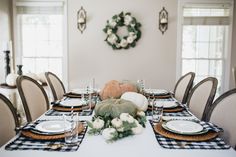 a dining room table set for thanksgiving dinner