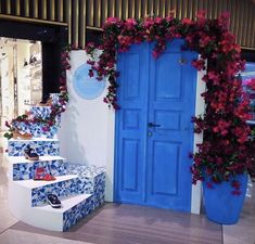 a blue door and steps decorated with flowers