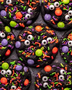 cookies decorated to look like monster faces with candy eyes and candies on them for halloween