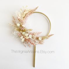 a headband with flowers and leaves on top of white background, close up view