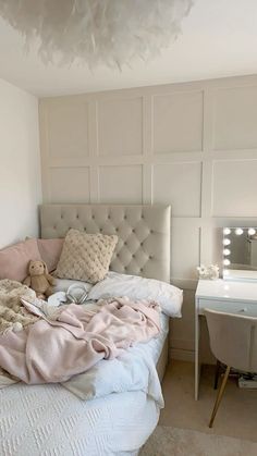 a bedroom with a bed, desk and mirror