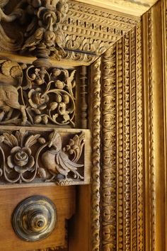 an ornate wooden door with carvings on it