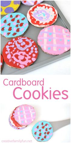 some cookies are decorated with pink, blue and red icing on a cookie sheet