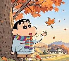 a cartoon boy standing next to a tree with fall leaves on the ground and houses in the background