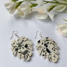 These stunning jesmonite earrings in monochrome tone are handmade from eco-friendly jesmonite. Jesmonite is solvent free, low VOC and heat proof. Each earring has been hand sanded and sealed with coconut oil.  Each earring is unique and will have slight natural variations - colour, texture and tiny air bubbles.  Earring hooks in a bright silver tone. Lead and nickel free silver plated. Dimensions:  Length: 6 cm approx.  Size of monsters leaf: 4 x 3.3 cm  Although jesmonite is a fairly strong mat Handmade White Leaf-shaped Earrings, Modern White Resin Earrings, Jesmonite With Glitter, Jesmonite Gold Leaf, Jesmonite Earrings, Jesmonite Terrazzo, Jesmonite Soap Dish, Eco Resin, Monstera Leaf