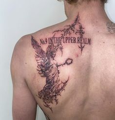 the back of a man's upper half with an angel and words on it