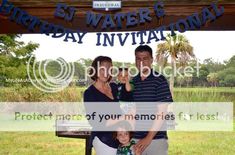 the family is posing for a photo in front of the birthday sign at the park