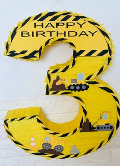 a yellow construction themed birthday cake with the number six on it's front and back