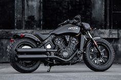 a black motorcycle parked in front of a building