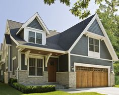 a large house with two garages on the front and one above it's door