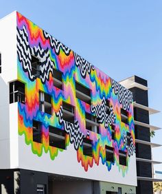 a multicolored building with windows and balconies