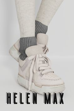 the legs and feet of a person wearing white sneakers with grey socks on top of them