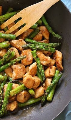 chicken and asparagus stir fry in a wok