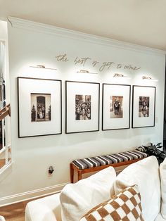 a living room filled with furniture and pictures on the wall