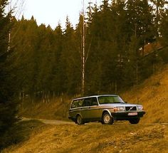 a van driving down a dirt road in the woods