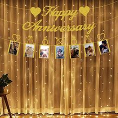 a happy anniversary banner with pictures hanging on it