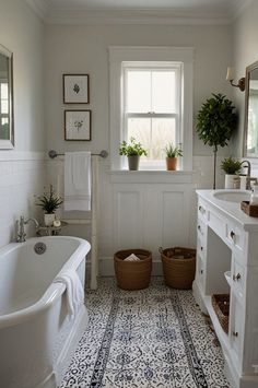 a bath room with a tub a sink and some plants in baskets on the floor