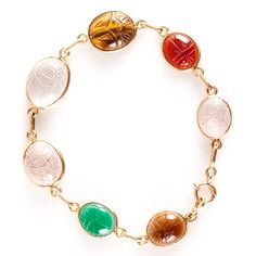 14k Yellow Gold Oval Cabochon Scarab Style Multi-Stone Bracelet 11.05gMetal Information: 14k Yellow GoldTotal Weight: 11.05gBracelet Width: 13mm - 3.5mmBracelet Length: 7.5"Stone InformationMain StoneGem Type: QuartzShape: Oval Cabochon (15.7mm x 11.75mm)Color: ClearClarity/Quality: ANumber of Stones: 1Accent StonesGem Type: QuartzShape: Oval Cabochon (13.2mm x 11.2mm / 11.8mm x 9.9mm)Color: Pink ClearClarity/Quality: ANumber of Stones: 2Accent StonesGem Type: AgateShape: Oval Cabochon (11.5mm x 9.4mm)Color: RedClarity/Quality: ANumber of Stones: 1Accent StonesGem Type: AgateShape: Oval Cabochon (11.5mm x 9.8mm)Color: Orange RedClarity/Quality: ANumber of Stones: 1Accent StonesGem Type: Tigers EyeShape: Oval Cabochon (13.7mm x 11.4mm)Color: BrownClarity/Quality: ANumber of Stones: 1Accent Oval Cabochon Bracelets For Formal Occasions, Luxury Oval Bracelet With Natural Stones, Luxury Oval Bracelets With Natural Stones, Multi Stone, Oval Cabochon, Stone Bracelet, Color Orange, Yellow Gold, Stone