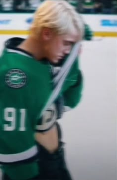 a man with blond hair is standing in front of an ice hockey goalie uniform